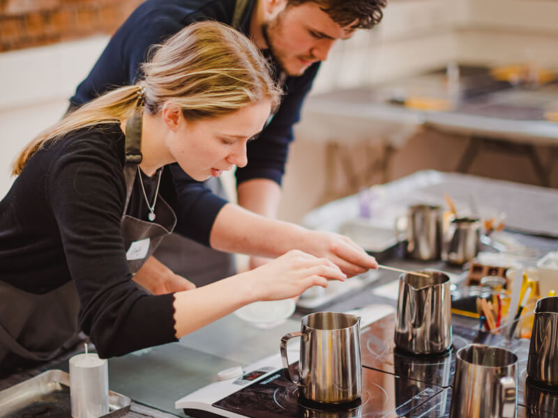 woman and man making candles